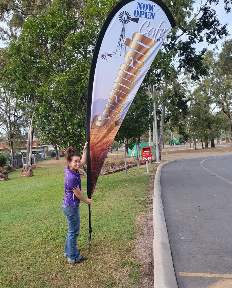 Savannah Café Manager putting up the sign to commence